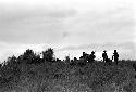 warriors crouching trying to stay hidden while working their way up to the top of the knoll of the Warabara