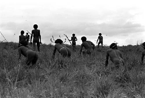 warriors crouching trying to stay hidden while working their way up to the top of the knoll of the Warabara