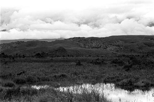 men crossing the swamp towards the Warabara