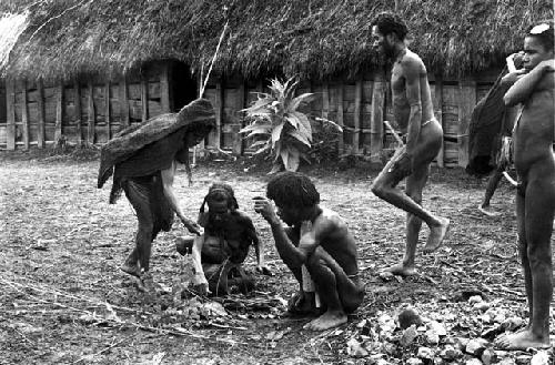 women come to give things to put into the magic bundle that will be placed outside of the sili