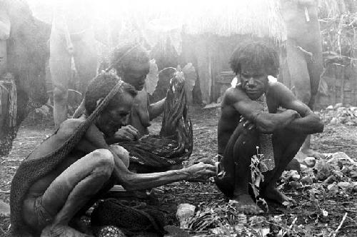 women taking things off their sus and little bits of tobacco to put into the magic bundle