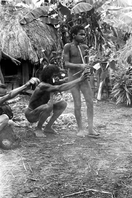 Wali performs some part of the ceremony; gives the branches to two small boys