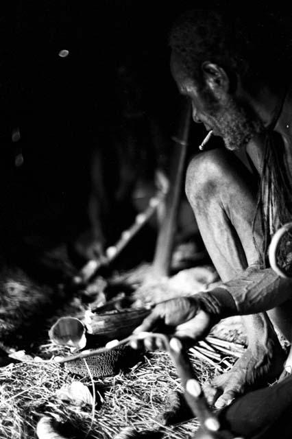 inside a honai; Asuk inspects a nyeraken aré; measure it