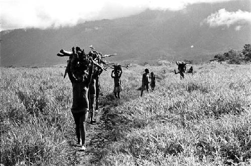 women carrying loads of wood on their heads towards Abukupak from the north