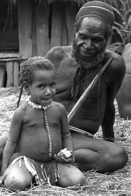 Polik sits; young girls is looking at the camera