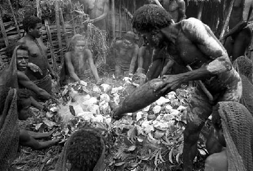 a man pours water on the hot stones