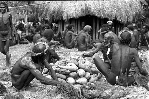 men arranging a pile of hiperi