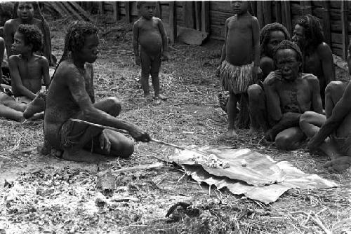 Molaré picking Weaké's bones out of the ashes of his fire