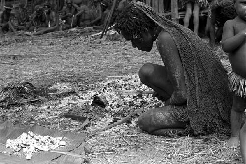 Molaré picking Weaké's bones out of the ashes of his fire