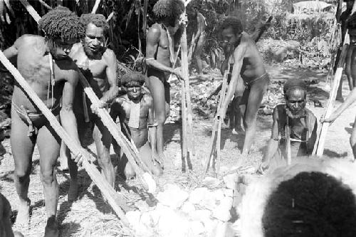 men carrying hot stones