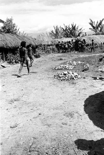 woman carrying a load of firewood into the sili