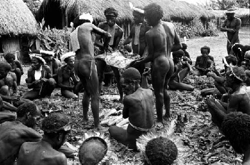 men cutting pig meat