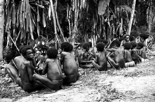 children eating pig; people greasing each other