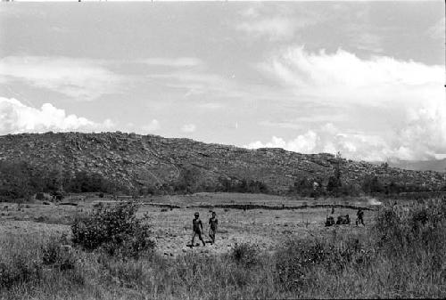 Figures in fields near Puakoloba