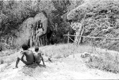 Figures seated on a rock near Lokoparek