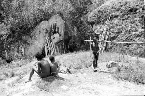 Figures seated on a rock near Lokoparek