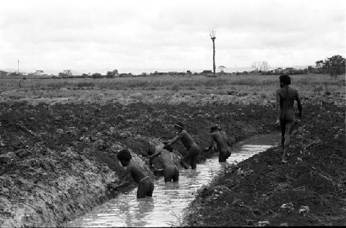 Men working on irrigation ditch