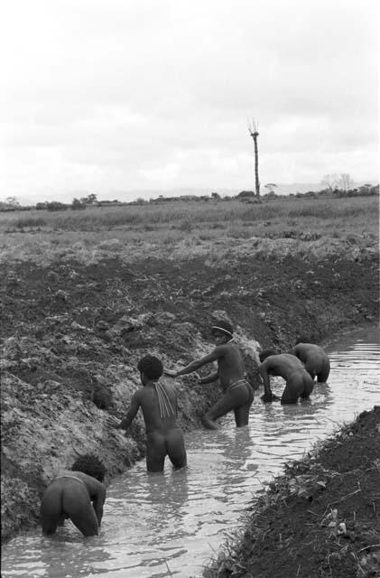 Men working on irrigation ditch