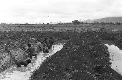 Men working on irrigation ditch