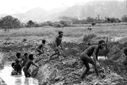 Men building irrigation ditches