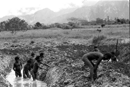 Men building irrigation ditches