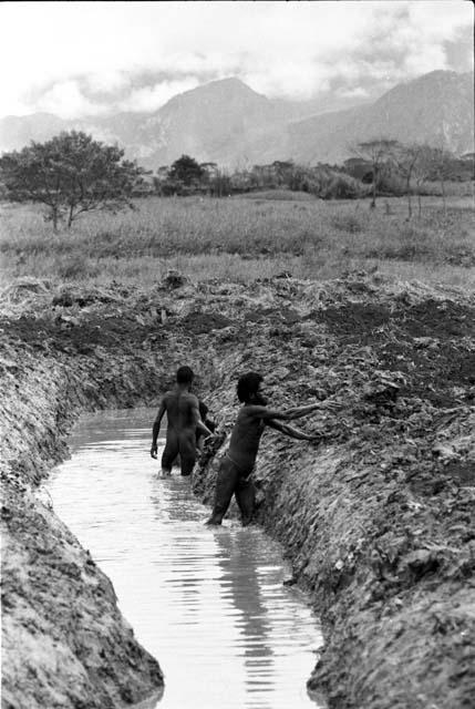 Men building irrigation ditches