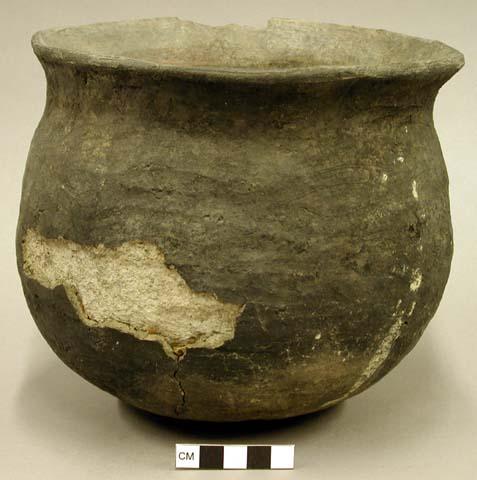 Complete jar, flared chipped rim, surace chipped, cracked and fire cloud