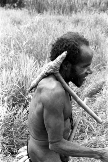 Abulupak man with stone axe and bananas