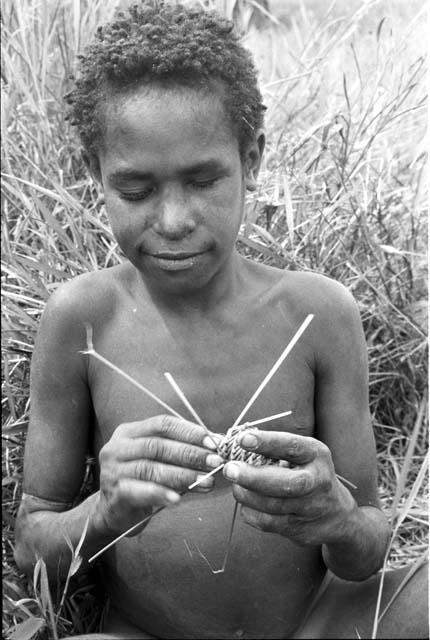 Young warrior making toy