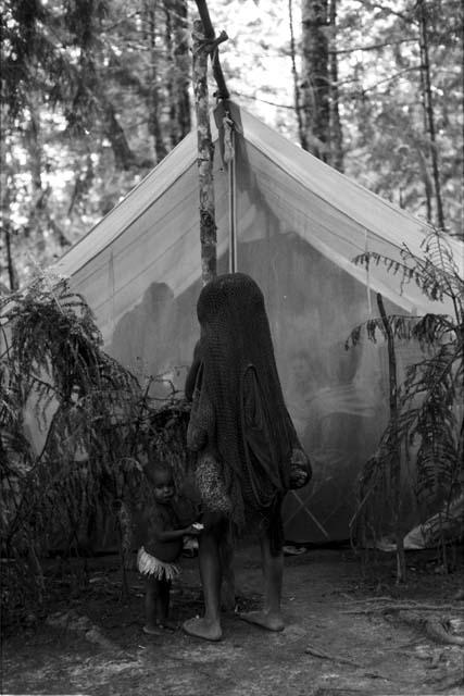 Woman and girl outside the eating fly