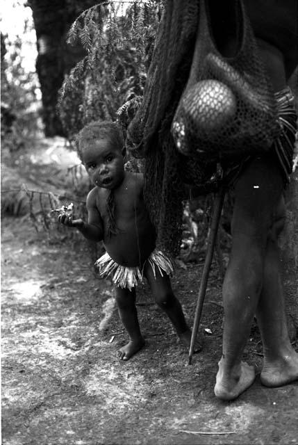 Woman and girl outside the eating fly