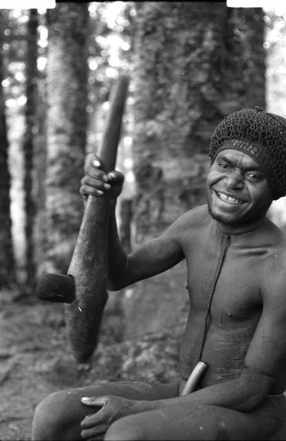 Man sitting with axe