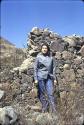 Figure standing in front of stone wall at Pinit (U2343), a hill-top fort