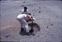 Crew at work excavating test pits in the loose dry sand at preceramic midden site on Alto de Salaverry. Andres Castillo and Michael Moseley shown at work at the site.