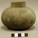 Ceramic vessel, serrated around base, sherds inside