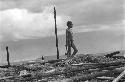 Boy standing by pole