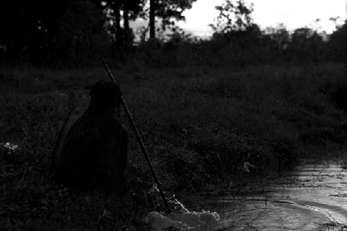 Person fishing by water