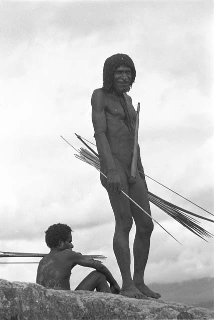 Man standing with bow and arrows