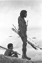 Man standing with bow and arrows