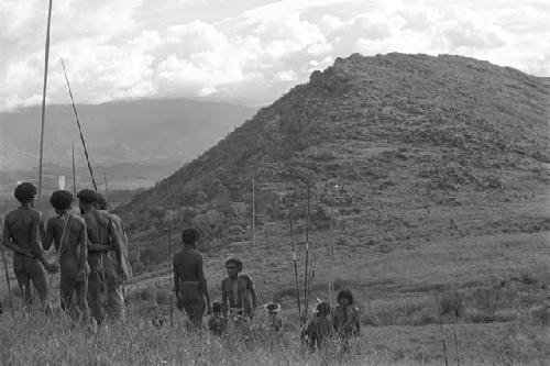 Men standing with hill in the distance