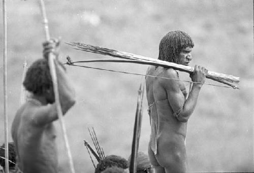 Men carrying bows and arrows