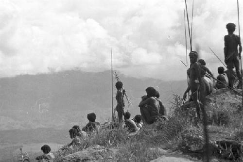 Men with poles in field