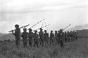 Men walking in line with poles