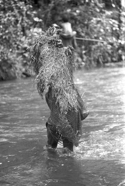 Man standing in rover covered in a net