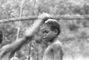 Blurred image of two boys; one throwing a spear