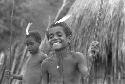 Two boys holding spears