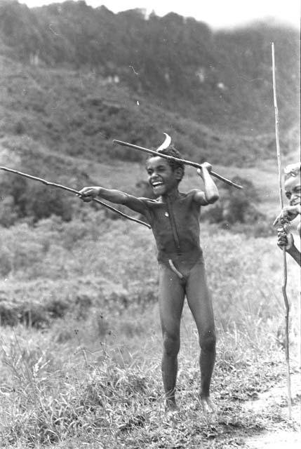 Young boy with two spears