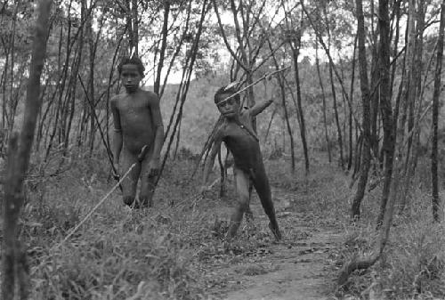 Young boys throwing spears