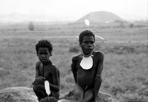 Two boys sitting on a rock