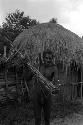 Man carrying an axe and a bow and arrow